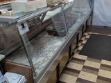 a large display case in the middle of a kitchen