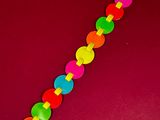 a close up of a colorful plastic toy on a red surface