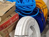 a pile of hoses and boxes on the floor