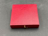 a red box with a lock on a table