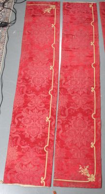 a red table cloth with gold trims on it