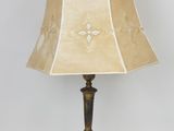 pair of brass table lamps with shades on each side and a lamp shade on the other side