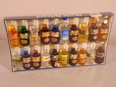 many bottles of alcohol in a box on a table