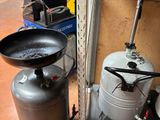 a black frying pan and a black frying pan sitting on top of a metal table