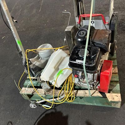 a small machine that is sitting on a pallet in the street