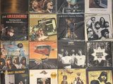 a lot of records on the wall of a room