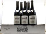 three bottles of red wine sit on top of a box