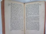 a book open on a white table with a red border