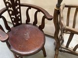 two wooden chairs sitting next to each other in a room