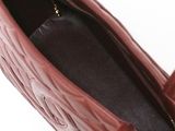 a close up of the inside of a handbag on a white surface