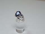 silver ring with a blue stone in the middle of it
