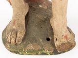 an old statue of a dog with a red collar on a white background