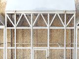 a small bird cage with a bird inside of it