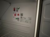 a refrigerator with stickers on the door and a sticker on the door