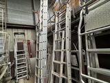 many ladders that are sitting in a room