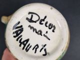 a person holding a cup with writing on it
