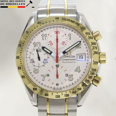 a silver and gold watch with a red second hand
