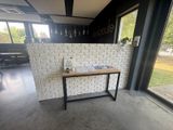 a table with a book on it in front of a window