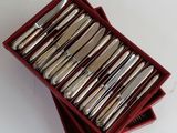 a lot of silverware in a red box on a table