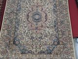 many rugs that are on display on a table