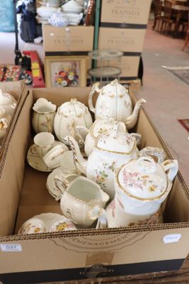 a box full of teapots and cups sitting on a table