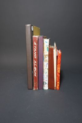 several books are stacked on top of each other on a black surface
