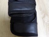a pair of black shoes that are on a wooden floor