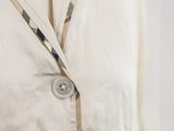 a close up of a shirt with a button on it