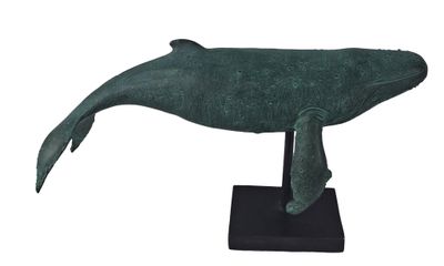 sculpture of a green whale on a black base