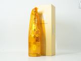 une bouteille de liquide posée à côté d'une boîte sur une table
