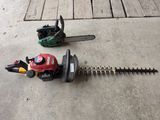 a small hedger and a chainsaw on the ground