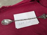 a silver spoon and a silver spoon on a red cloth