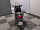 a motorcycle that is parked in a room with a checkered floor