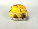 a small glass object with a picture of a man and a dog on it