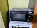 a toaster oven sitting on top of a microwave oven