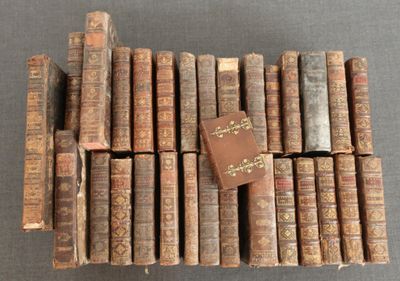 several old books stacked on top of each other on a table