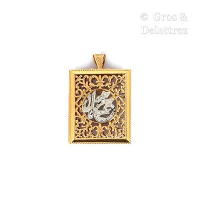 a close up of a gold and silver pendant on a white background