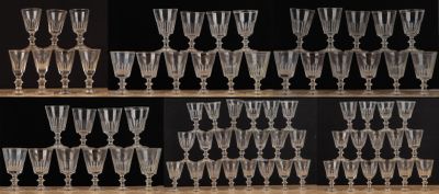 de nombreux verres à vin posés sur une étagère dans une pièce