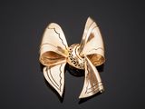 gold bow brooch on a black background