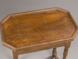 an old wooden table with turned legs and a wooden top