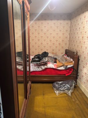 an image of a bedroom with a bed and a closet