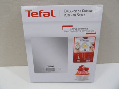 the box is open on a white counter top with a cupcake in it
