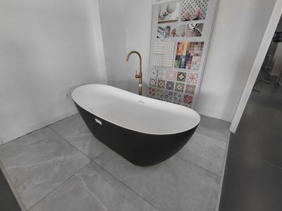 a black and white bathtub sitting in a bathroom