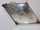 a silver tray with holes in it sitting on a table