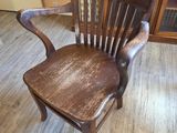 a wooden chair that is sitting on a wooden floor