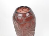 a brown vase with a design on it on a white surface