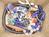 a basket filled with assorted beads and other items