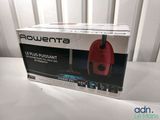 packaging of a red remote control sitting on top of a white table