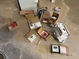 a pile of electronic equipment on the floor in a garage