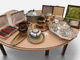 a table that has a lot of silver items on it